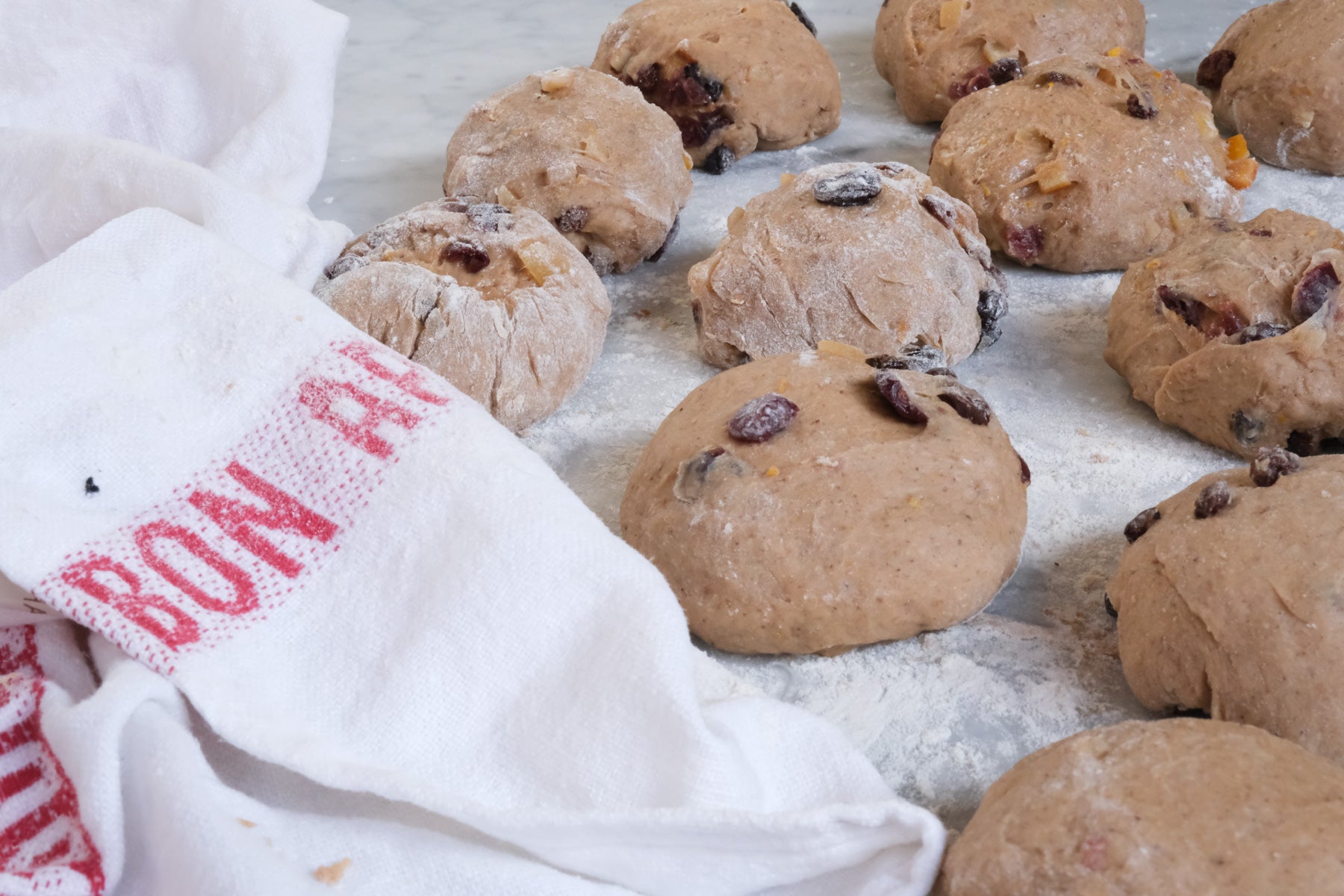 a close up of hot cross buns proving 