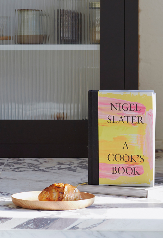 Nigel Slater's cook book next to a Selwyn House oak plate