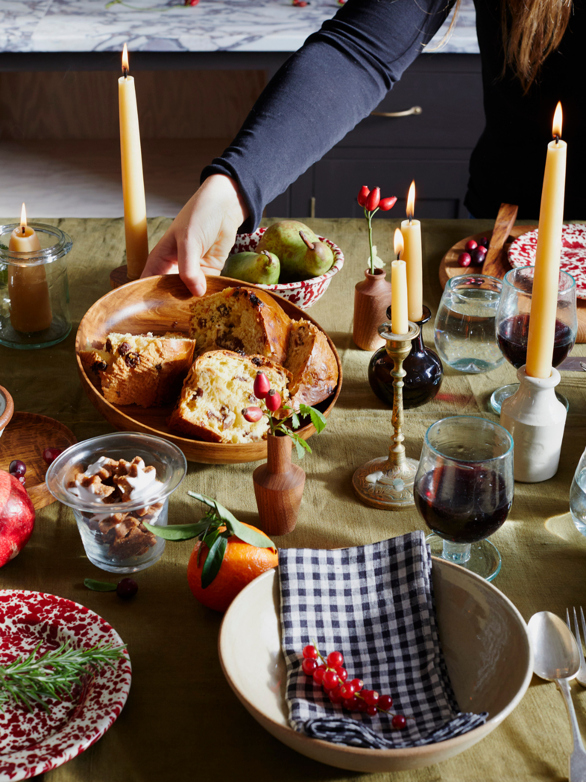 A Christmas table with food, candles and napkins