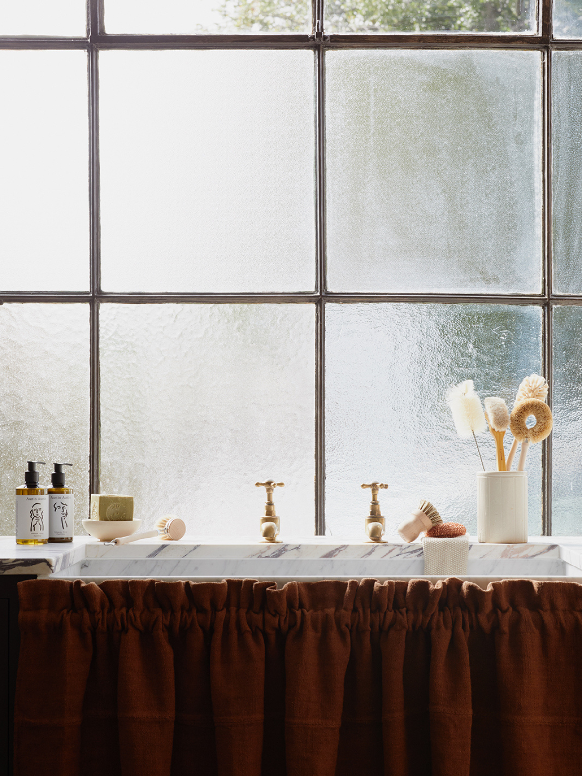 Objects around a tidy kitchen sink scene