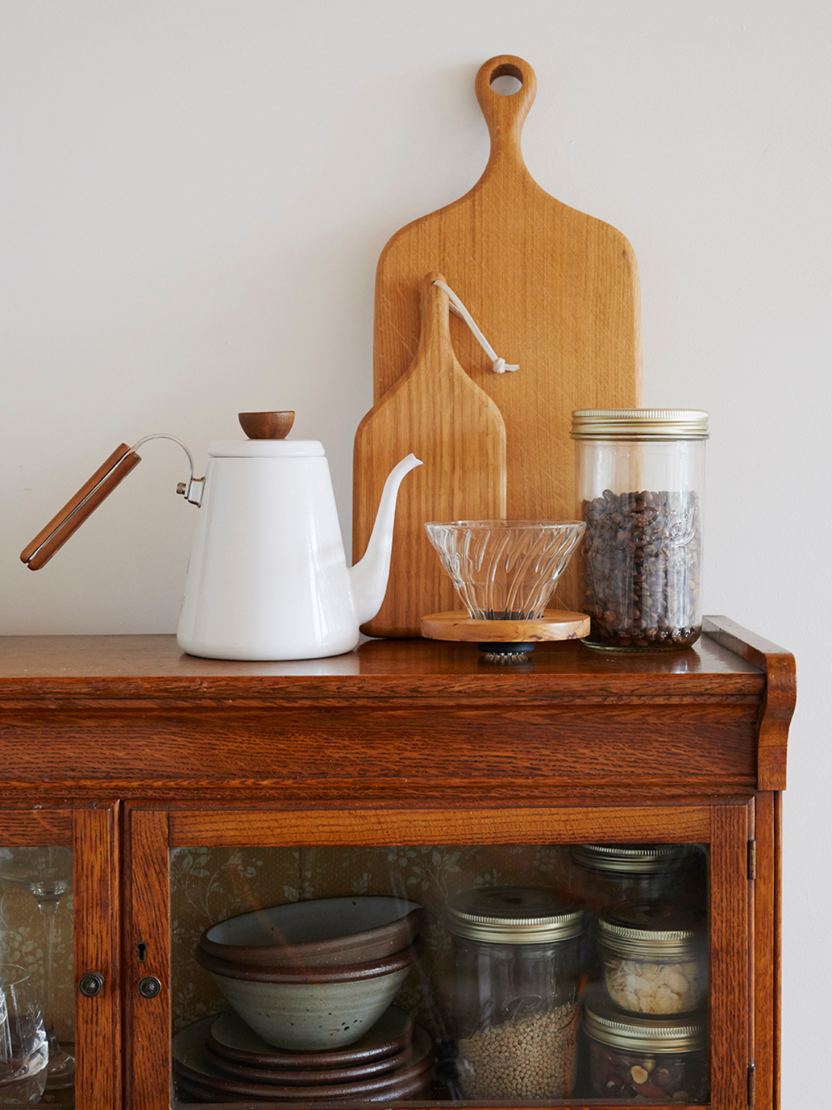 An enamel coffee pot on top of a cupboard