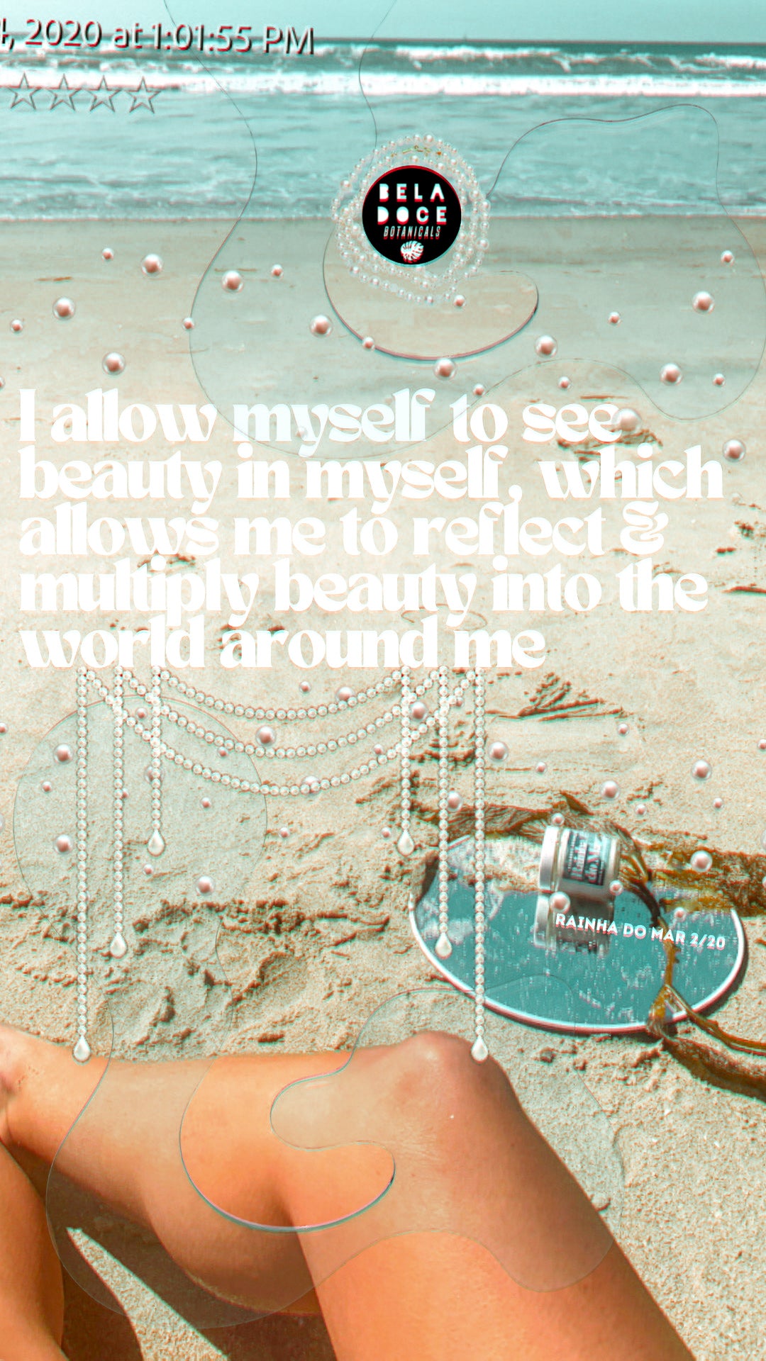 I see beauty in myself which allows me to reflect & multiply beauty into world around me” image description: horizon of a beach, a behind the scenes photo of a beladoce botanicals product shoot. a mirror lays on the sand with kelp laid across with a beladoce botanicals rainha do mar candle in 2021