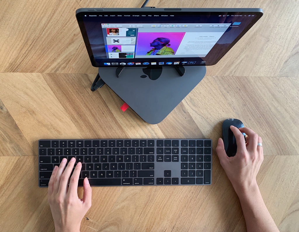 A computer sitting on top of an Apple product with Luna Display plugged in. 