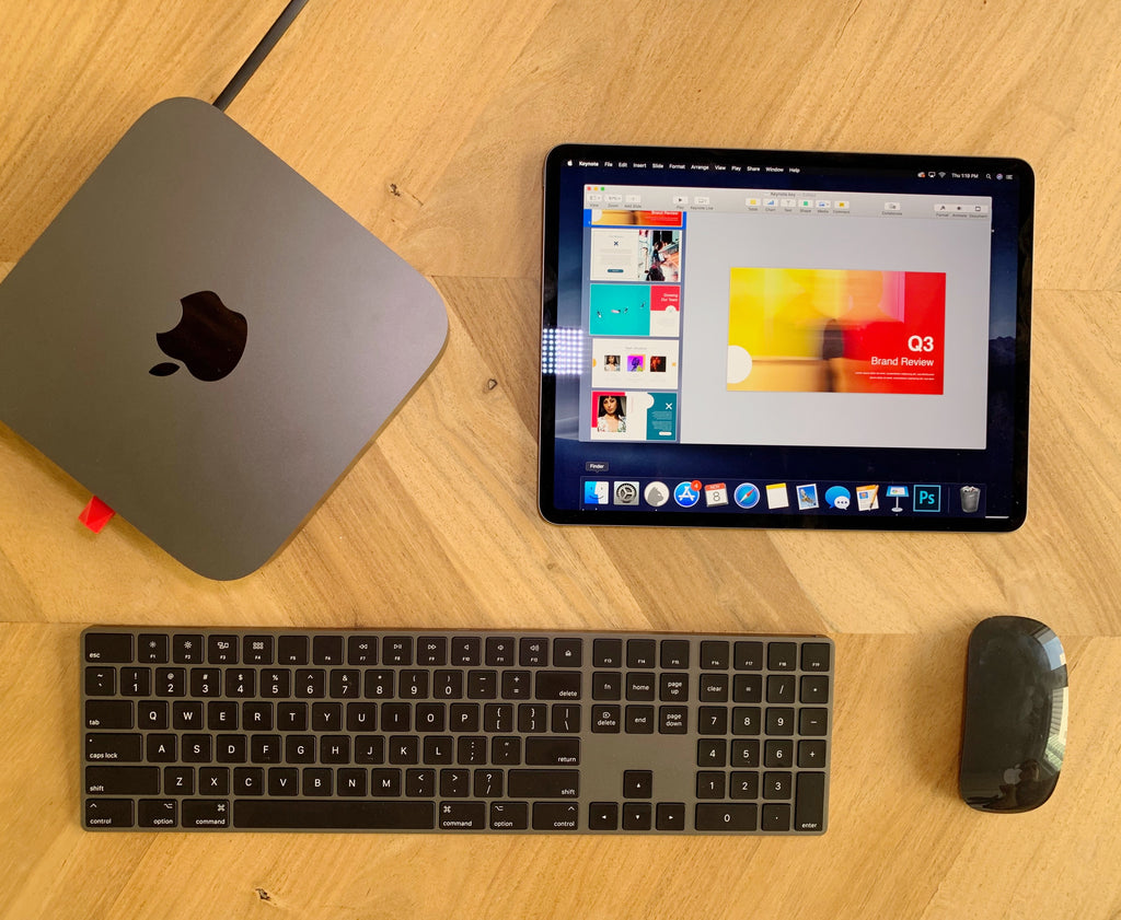 A wireless keyboard and mouse, tablet, and Mac with Luna Display. 