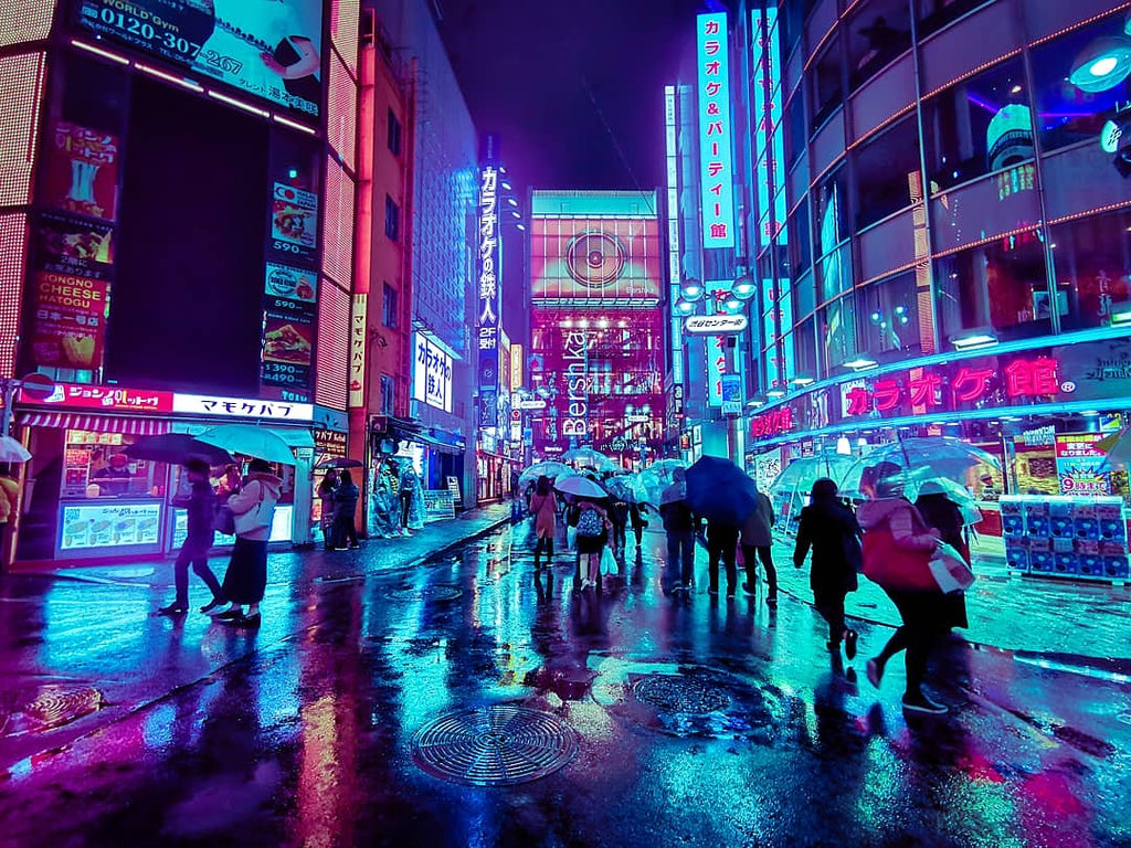 A bright Tokyo street bathed in blue light after a recent rainstorm. 