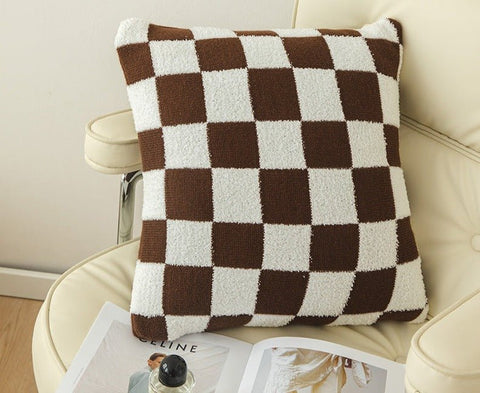 Brown Checkerboard Plus Boucle Cushion on a white, leather office chair.
