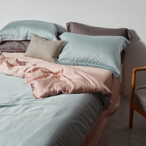 Our Joli Bedding Set - with a light blue colour on the outside of its sheets and a pink inside. 