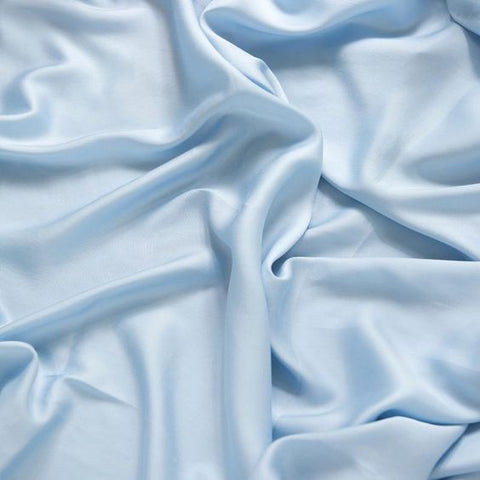 A close-up shot of blue, lyocell fabric