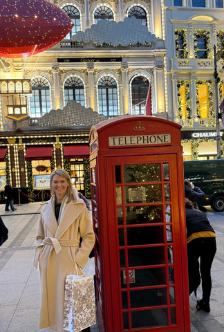 Lindsey Leigh Hohlt in her favorite coat next to a red telephone booth