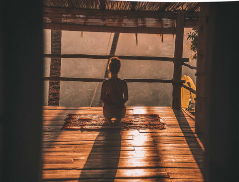 Woman meditating alone. Bali is a sacred place for yoga and meditation. Nyepi, day of silence,  is the perfect Balinese tradition to practice. 