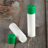 white lip balm tube green cap