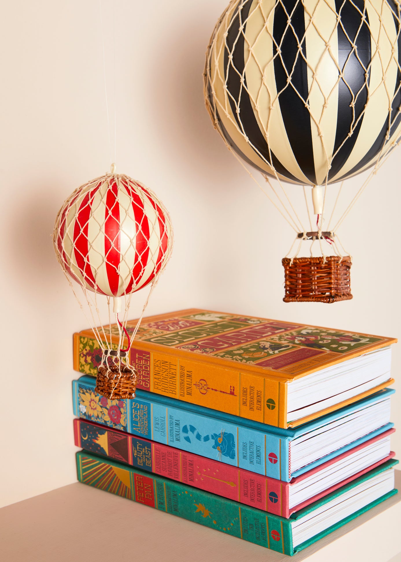 Stack of classic books with hot air balloon toys