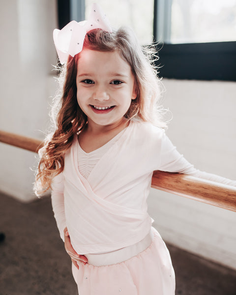 Little Ballerina at the Ballet Barre in Pink Crossover with Bow