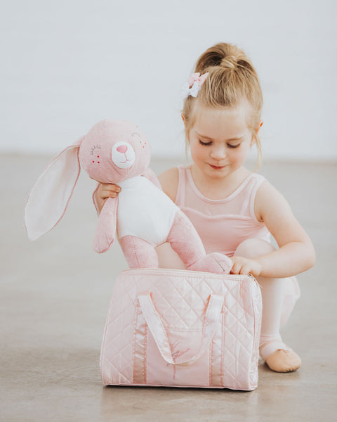 Little Ballerina putting bunnny in a her ballet bag