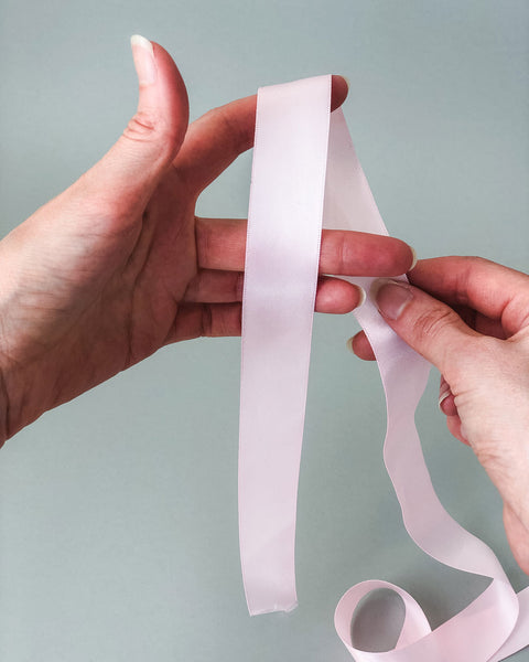 Step 1: Place ribbon over your index finger