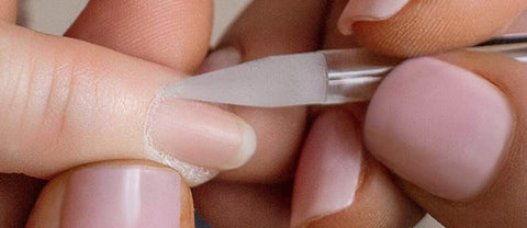 Using a glass cuticle pusher step2 pushing back the cuticle