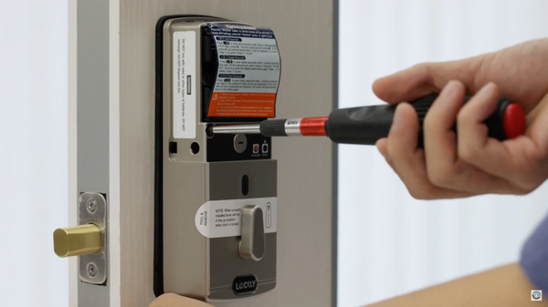 Installing a Lockly smart lock into a door.
