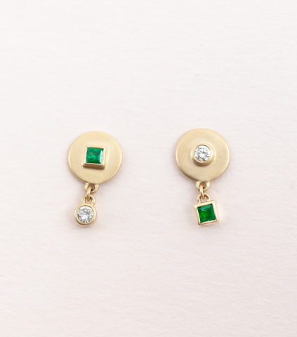 Two pairs of mismatch disc studs with dangling emerald & diamond in 14kt yellow gold.