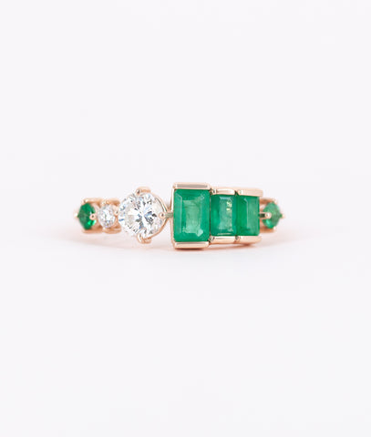 Sarah's three baguette emeralds are clustered together with her 2 diamonds and two of her small round emeralds prong set in 14kt rose gold. 