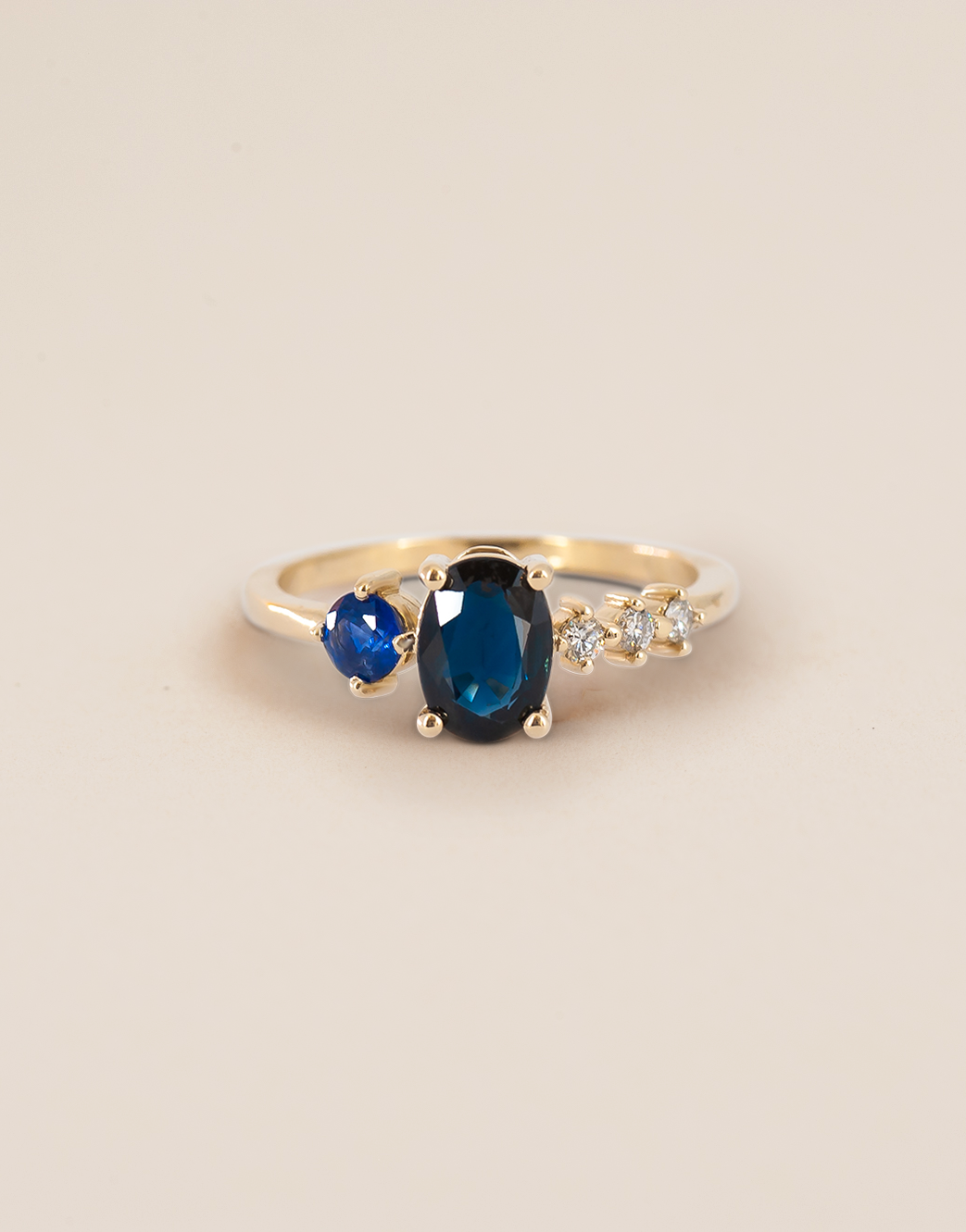Erin's asymmetrical sapphire ring with an additional round sapphire and white diamonds.