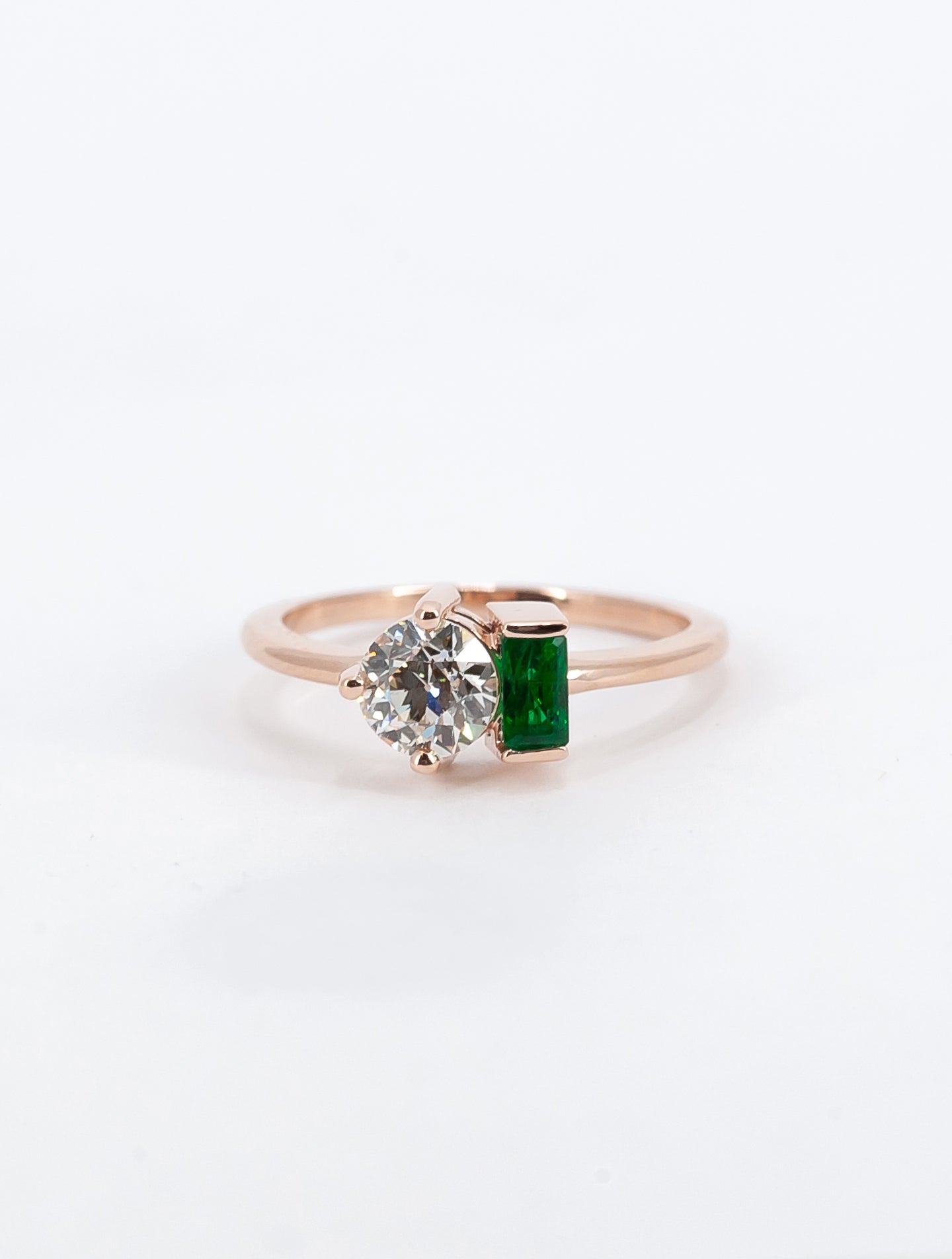 Mollie's diamond two-stone ring with an emerald baguette.
