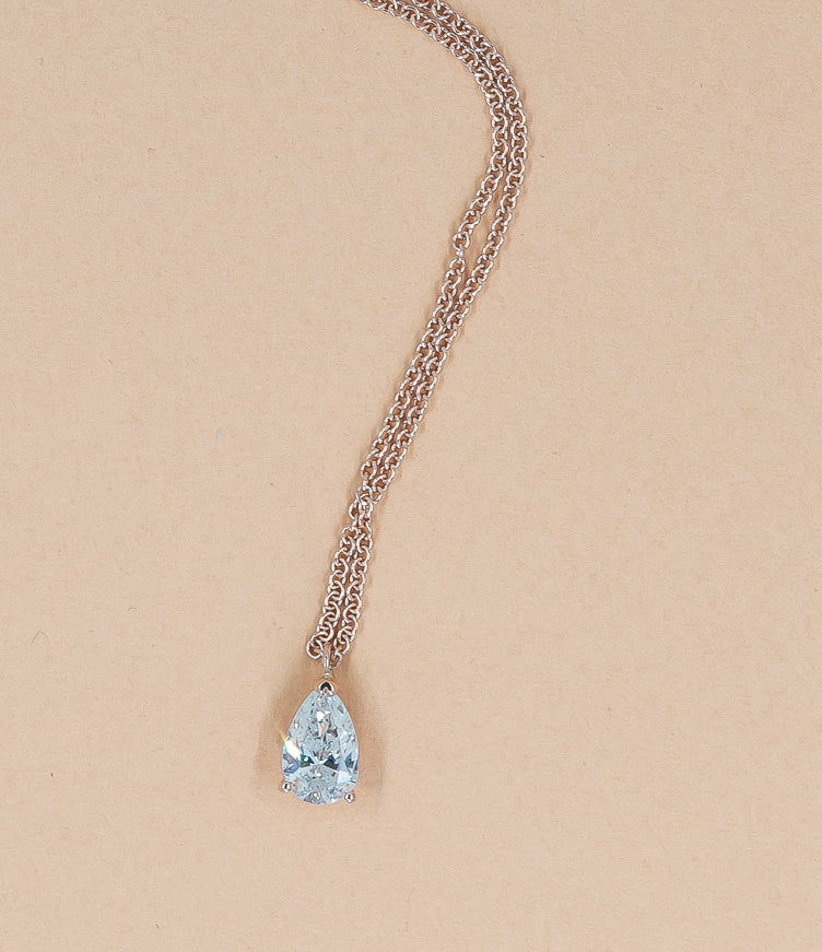 Mollie's pear shaped diamond set in a claw prong pendant. 