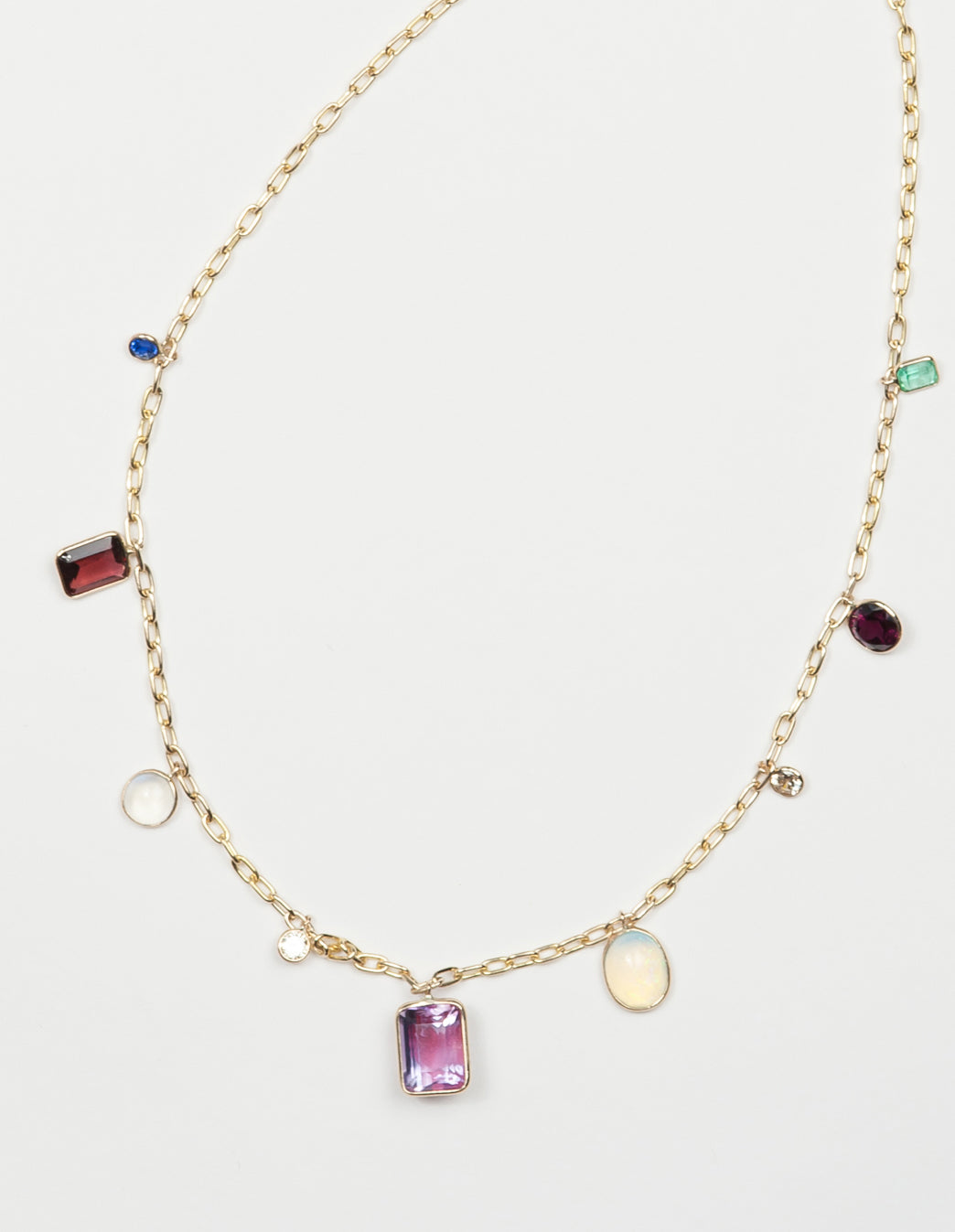 A lifetime of gem collecting >>> a gem charm necklace on a 14kt gold chain. 