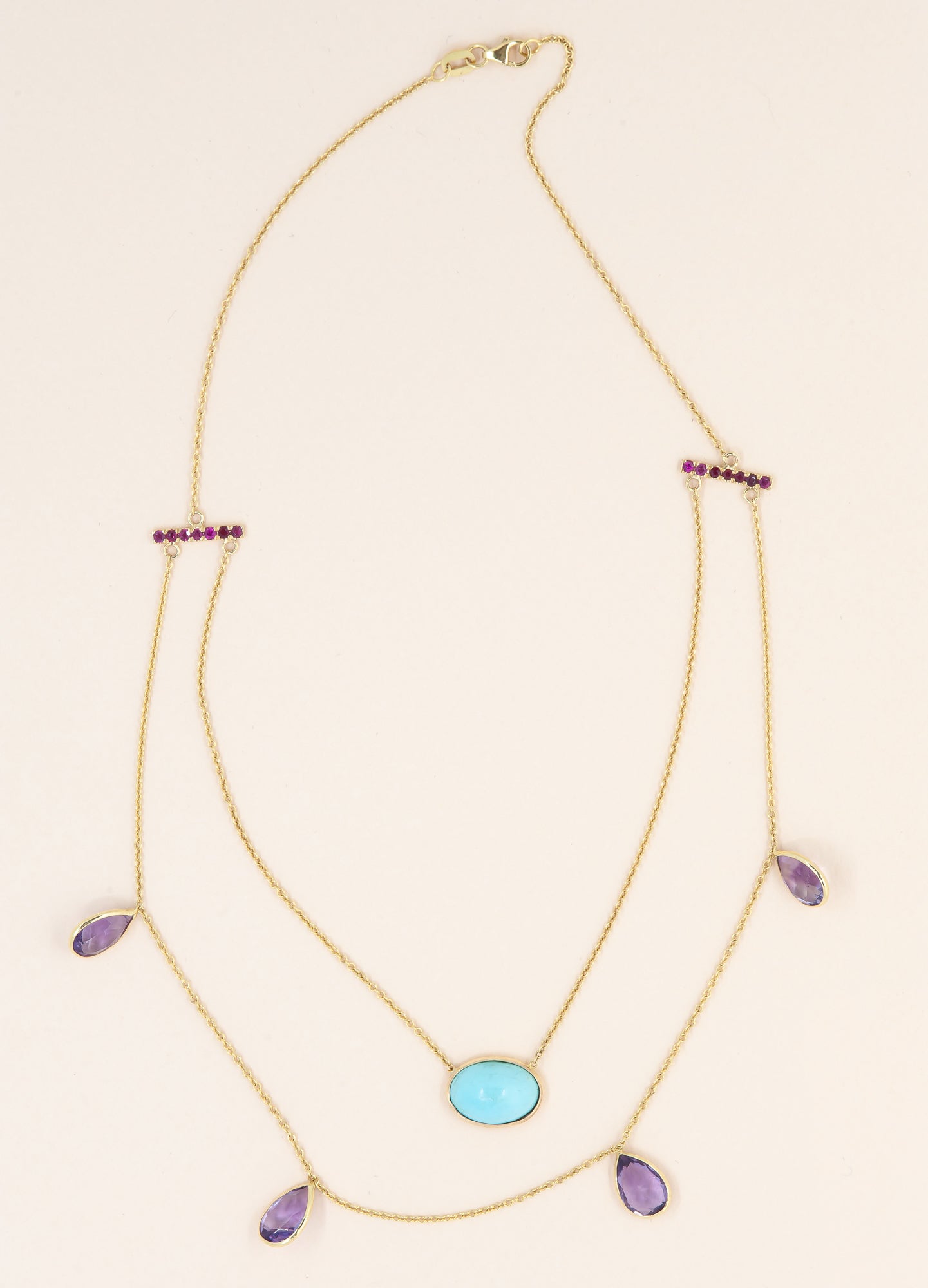 A layered necklace for Cathy with rubies, turquoise, and amethysts from multiple pieces in her collection.