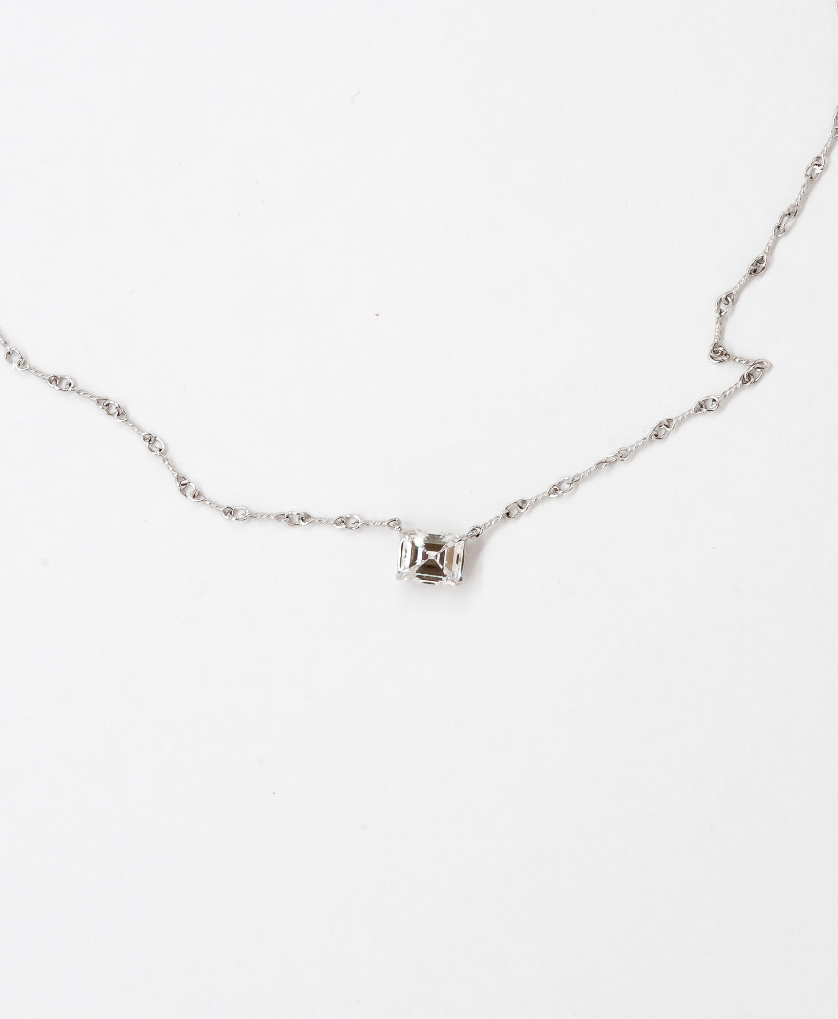 An inherited emerald cut diamond set in an antique style white gold chain for Ronna. 