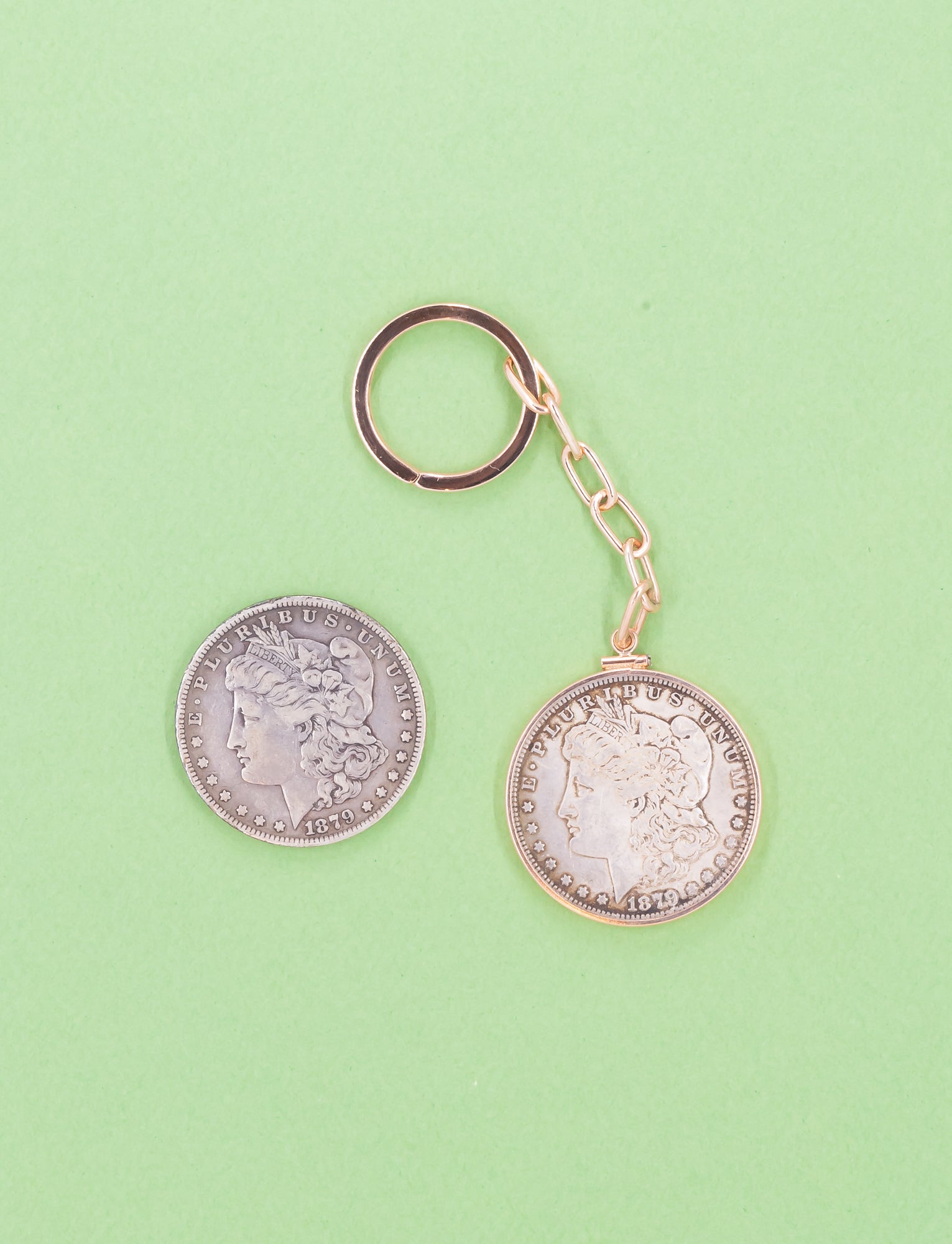 Coin keychain set in 14kt rose gold with a paperclip. 