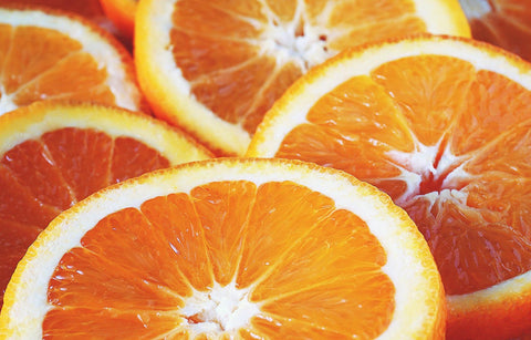 A closeup picture of vibrant and juicy halved oranges.