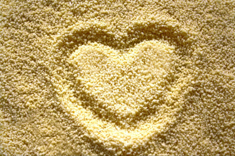 Uncooked grits with a heart drawn in the grains.