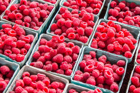 Side-by-side baskets filled with vibrant raspberries