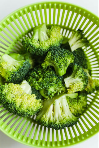Steamed broccoli in a green bowl