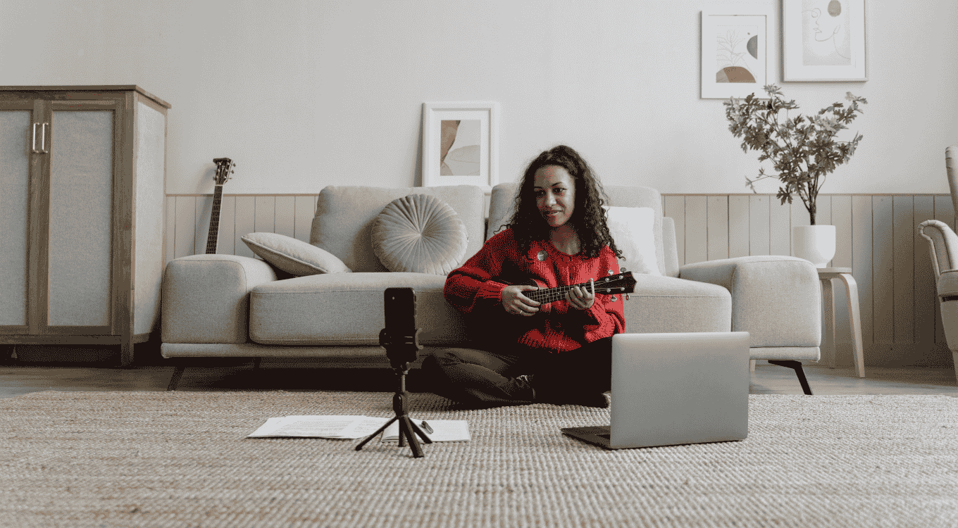 A female musician recording her music vlog using a wireless microphone