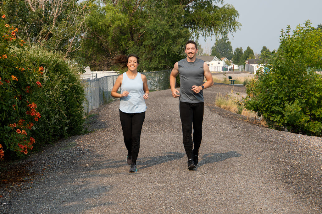 Couple running in AGOGIE Resistance Band Pants - The original resistance band pants