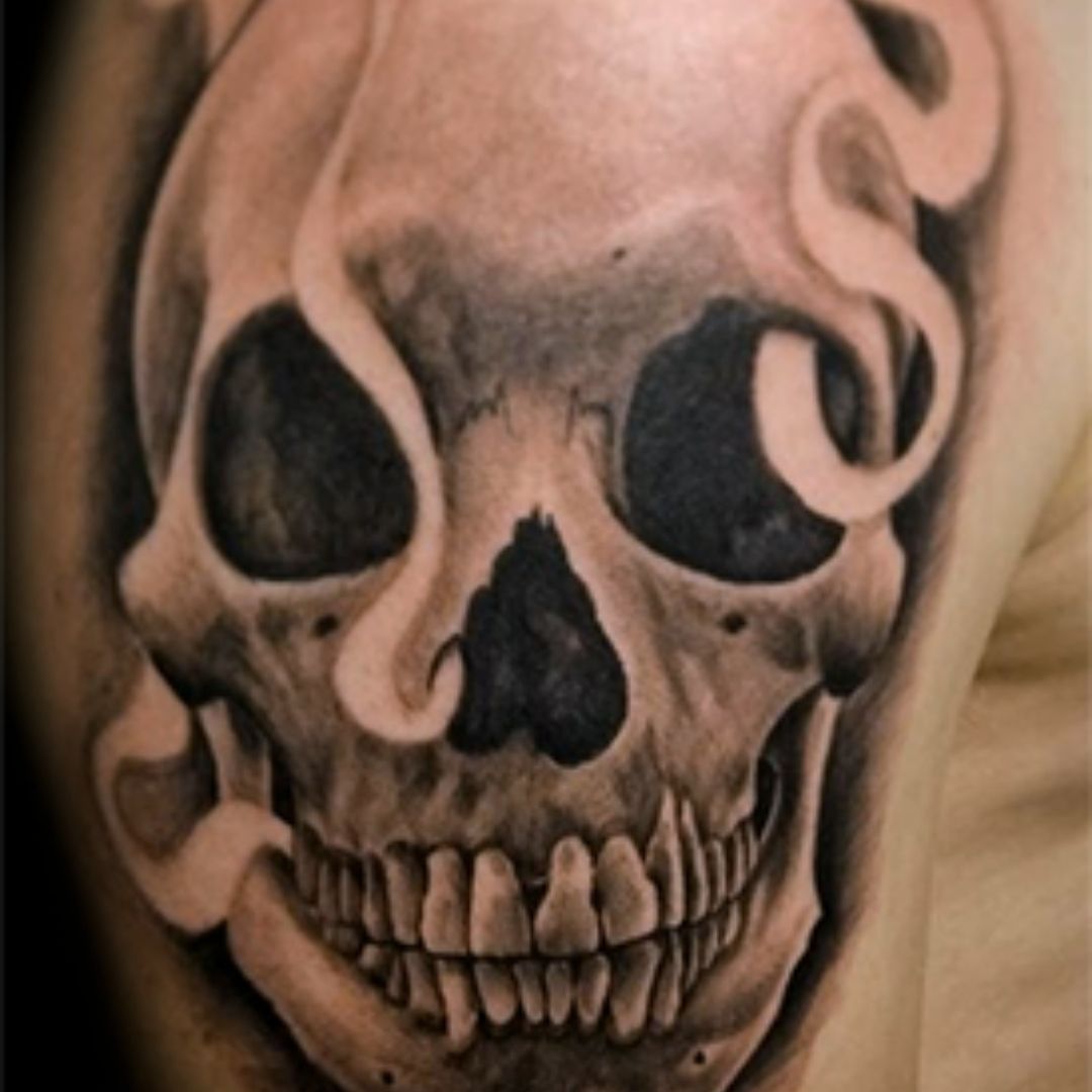 Grey shaded skull tattoo on right hand