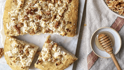 Catalan style coca bread with goat's curd, orange blossom honey and walnuts