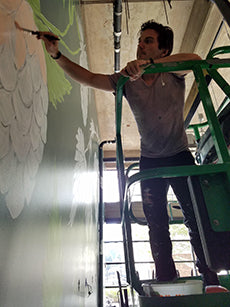 Sean Martorana in progress on a mural