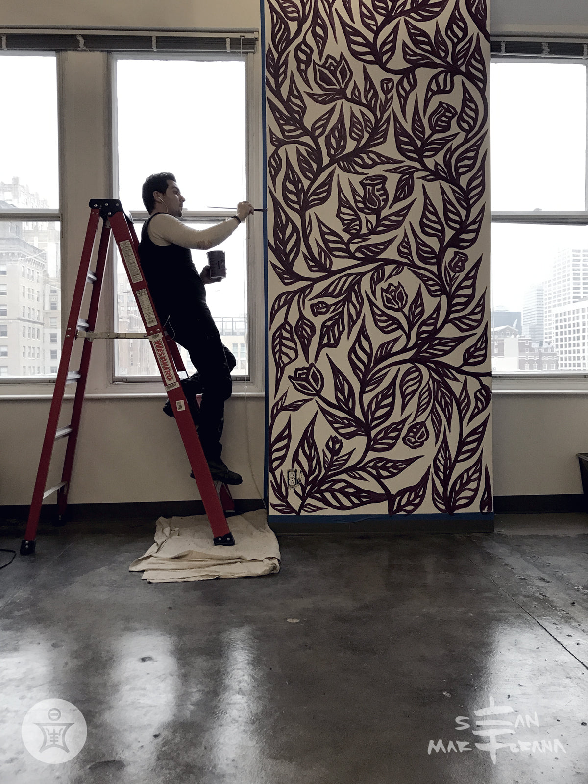 Sean Martorana painting and installing a Flourish Mural in Scribewise Philadelphia, PA