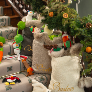 Three boucle santa sacks filled with presents