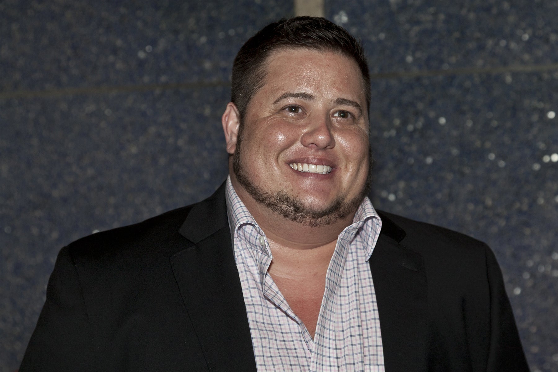 Chaz Bono, a white trans man, shown from the chest up. He is wearing a suit jacket and a checked shirt. Credit: lev radin / Shutterstock.com