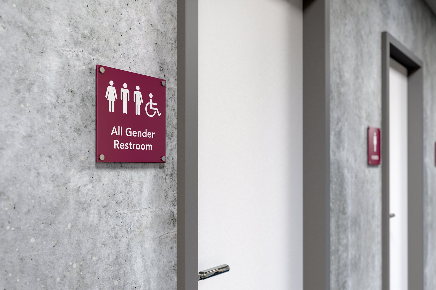 Image of a toilet door with a sign reading 'All Gender Restroom'