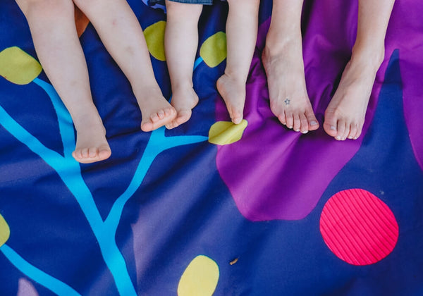 Mum and kids feet on Picnic Season Really Big Picnic Rug