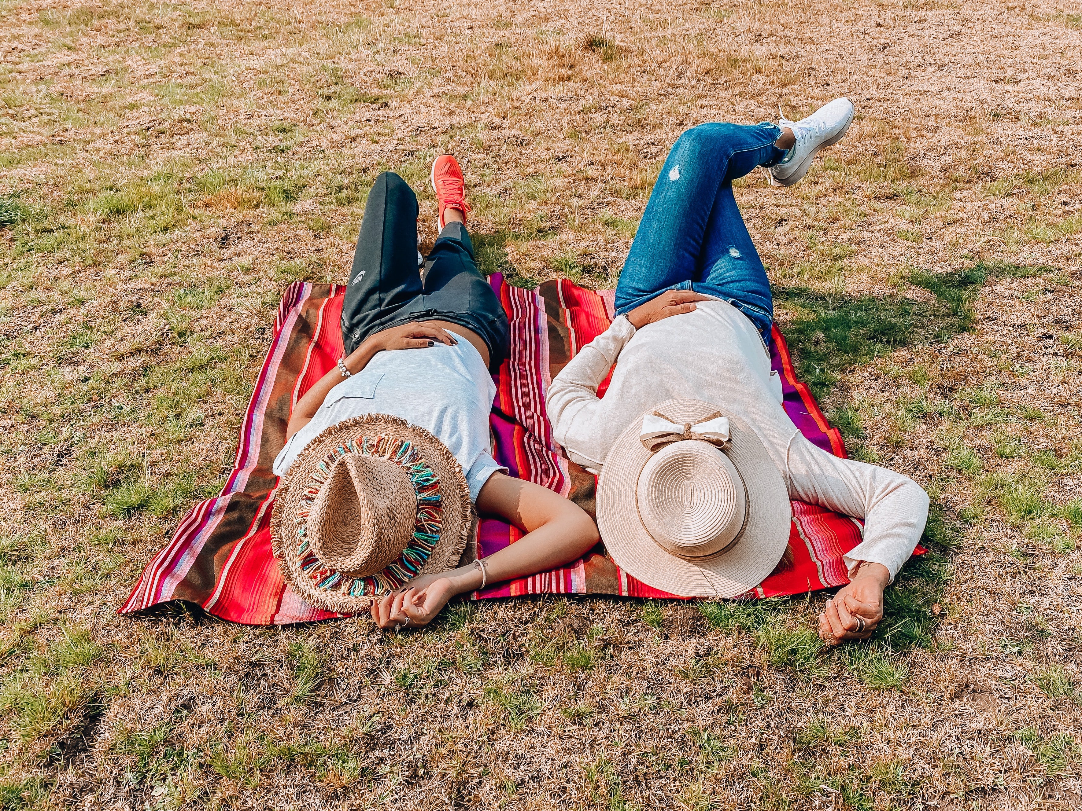 People lying under the sun with picnic hats