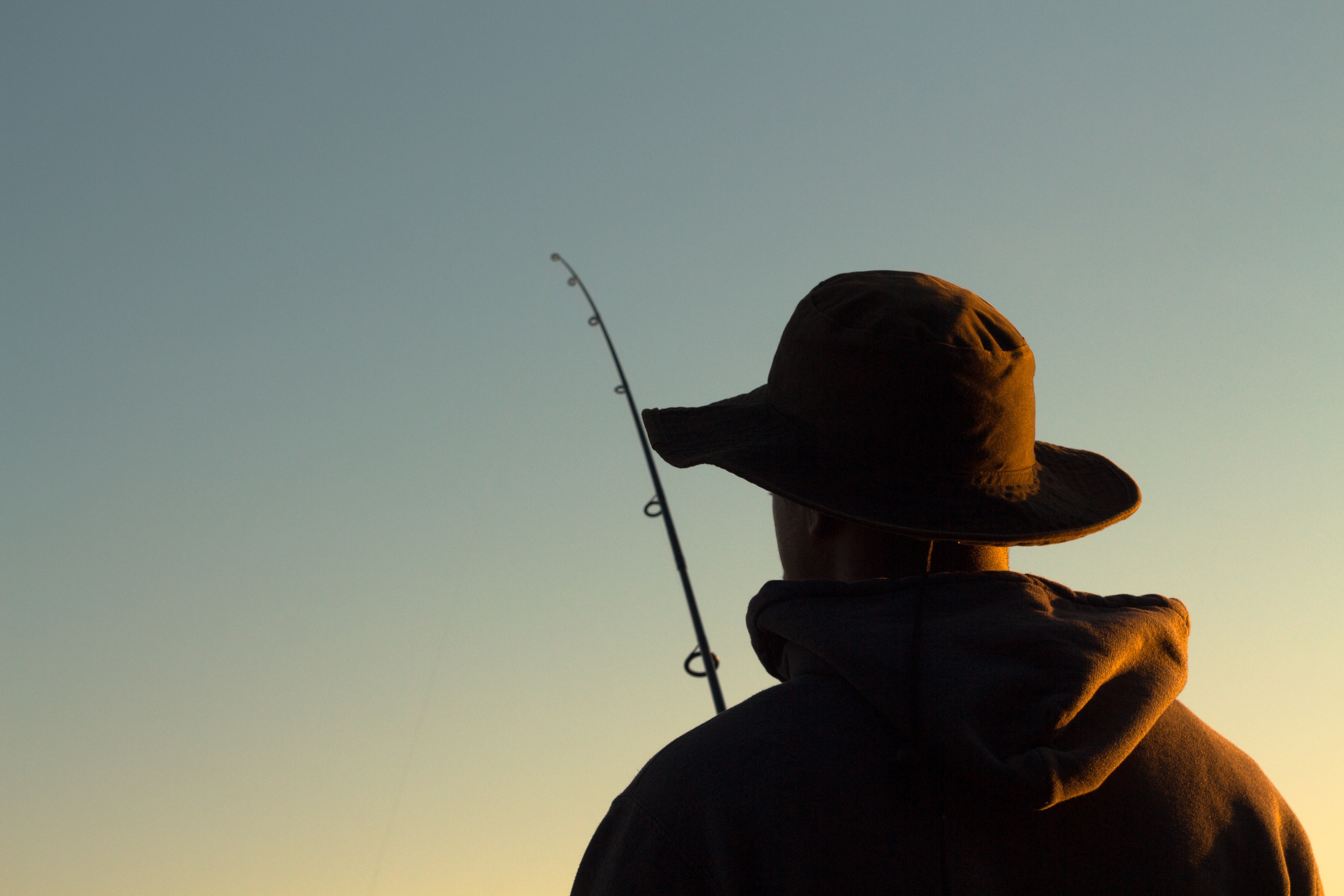 A man with a fishing hat