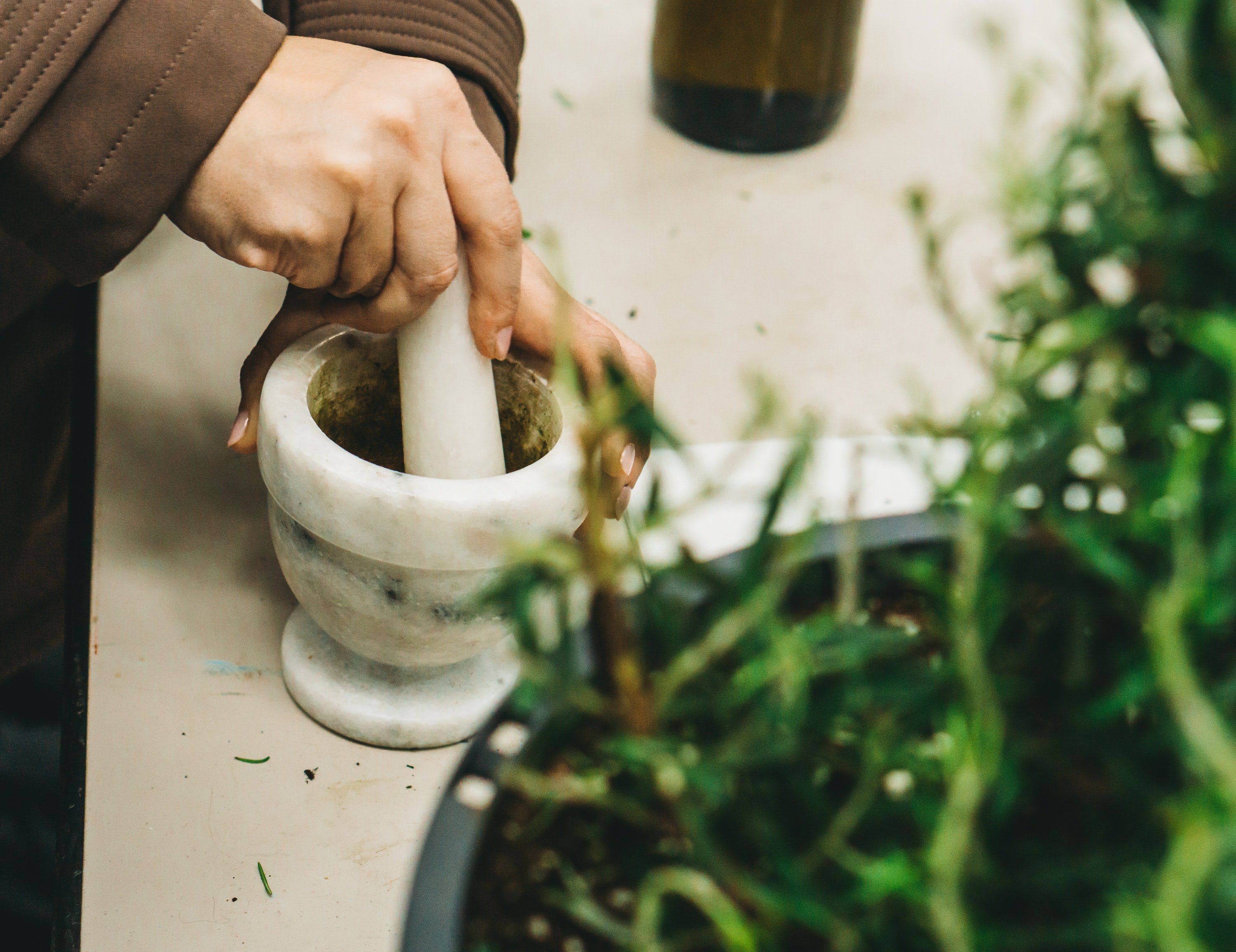 Rosemary being crushed and added into cooking