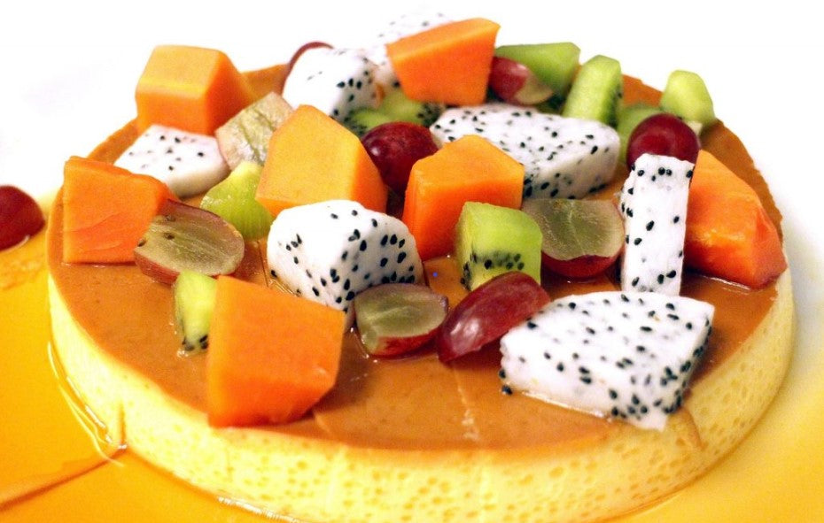 Caramel pie topped with tropical fruits such as papayas and dragon fruits
