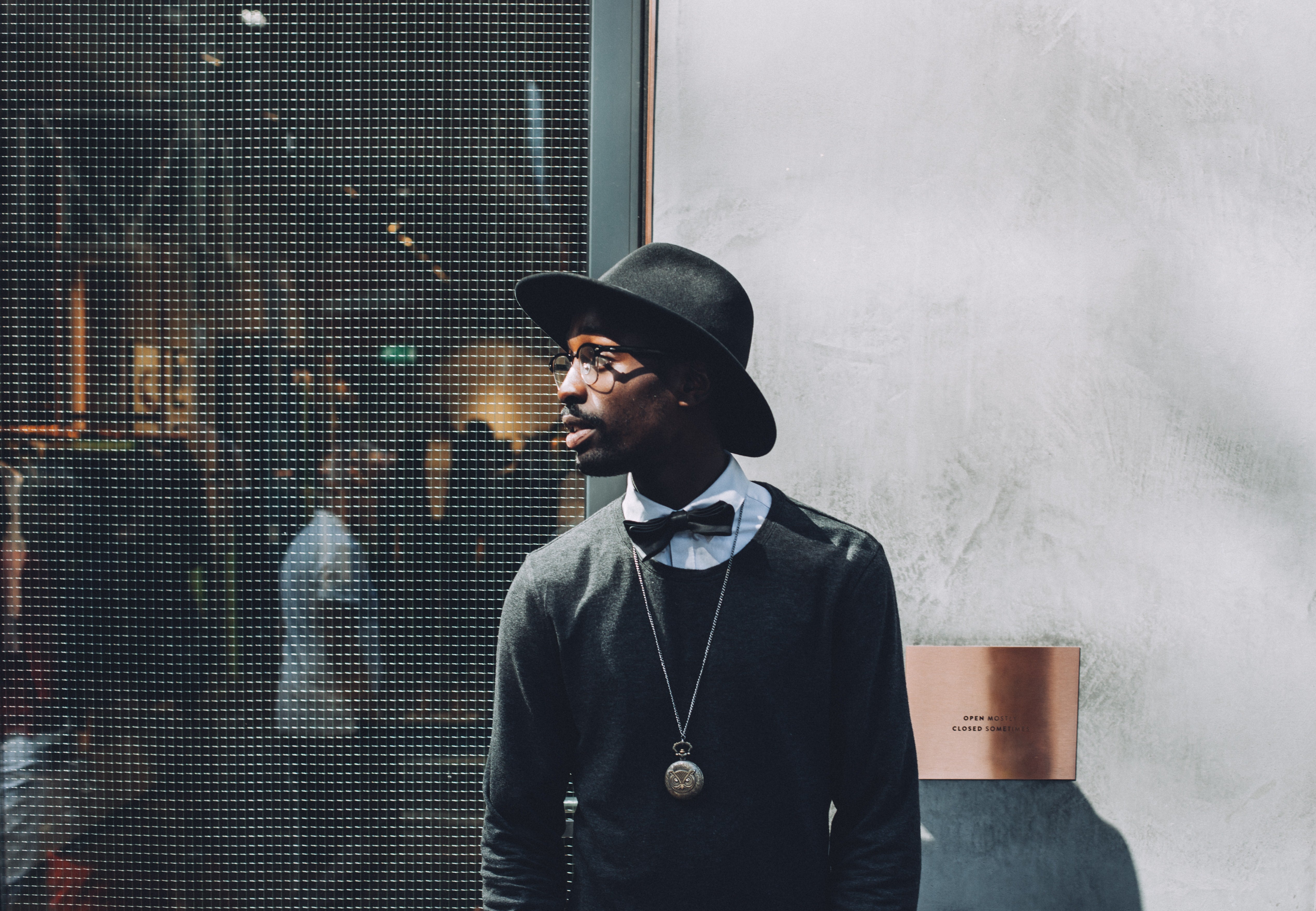 A fashionable man posing with a Panama hat