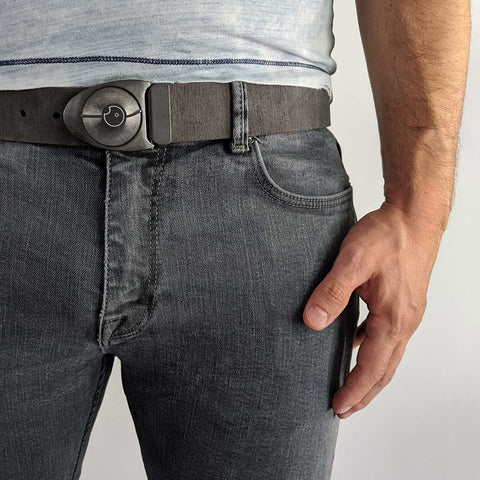 close up of cool mens belt buckle on distressed grey leather with dark jeans and blue t-shirt.